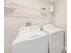 Laundry room with white washer and dryer, and wire shelving for storage at 8719 Winning Fields Rd, New Port Richey, FL 34655