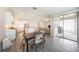 Open-concept kitchen and dining area with tile floors, sleek lighting, and access to the outdoor space at 8719 Winning Fields Rd, New Port Richey, FL 34655