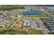 Aerial view shows a community pool with a playground and parking lot at 8719 Winning Fields Rd, New Port Richey, FL 34655
