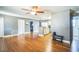 A cozy living area is detailed by hardwood floors, a ceiling fan and access to the rooms of the home at 9029 109Th Ave, Seminole, FL 33777