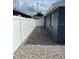 Backyard with privacy fence, pea gravel, and landscaped area at 9106 Telford Ct, Tampa, FL 33615