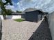 Backyard featuring pea gravel, a patch of grass, and a privacy fence at 9106 Telford Ct, Tampa, FL 33615
