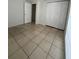 Bright bedroom featuring tiled floors, a closet, and a large window for natural light at 9106 Telford Ct, Tampa, FL 33615