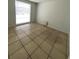 Bedroom with tiled floor and a large window providing ample natural light at 9106 Telford Ct, Tampa, FL 33615
