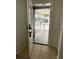 Home's entryway featuring tile flooring, screened-in porch, and a white front door at 9106 Telford Ct, Tampa, FL 33615