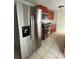 View of the kitchen with stainless steel appliances, wood cabinets, granite counters, and tiled flooring at 9106 Telford Ct, Tampa, FL 33615