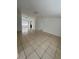 Spacious living room featuring tile flooring, white walls, and plenty of natural light at 9106 Telford Ct, Tampa, FL 33615