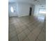View of the spacious living room featuring tile flooring, white walls and lots of natural light at 9106 Telford Ct, Tampa, FL 33615