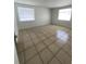 Bright living room with tiled floors and natural light from two large windows at 9106 Telford Ct, Tampa, FL 33615