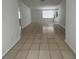 View of the spacious living room featuring tile flooring, white walls and lots of natural light at 9106 Telford Ct, Tampa, FL 33615