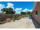 Spacious backyard featuring a concrete area with a wooden fence and various potted plants at 920 York Dr, Brandon, FL 33510