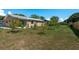 Expansive backyard featuring green lawns, fruit trees, and a home with a metal roof at 920 York Dr, Brandon, FL 33510