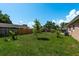 Spacious backyard featuring green lawns, fruit trees, and a wooden fence at 920 York Dr, Brandon, FL 33510