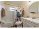 Bathroom featuring a vanity, toilet, tub, and decorative shower curtain at 920 York Dr, Brandon, FL 33510