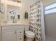 Bright bathroom featuring a vanity with storage, toilet and shower with decorative curtain at 920 York Dr, Brandon, FL 33510