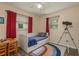 Cozy bedroom showcasing a daybed, desk, rainbow rug and abundant natural light from two windows at 920 York Dr, Brandon, FL 33510
