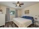 Cozy bedroom with wood floors, ceiling fan, a comfortable bed and a large window providing ample natural light at 920 York Dr, Brandon, FL 33510