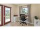 Bright home office featuring a modern desk, storage drawers and natural light from a window and glass paneled door at 920 York Dr, Brandon, FL 33510