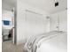 Bright bedroom with closet, ensuite, and neutral tones, including plush bedding and modern fixtures at 9485 Treasure Ne Ln, St Petersburg, FL 33702