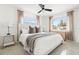 Bright bedroom with neutral tones, comfortable bedding, and plenty of natural light from the windows at 9485 Treasure Ne Ln, St Petersburg, FL 33702