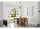 Well-lit dining area features a stylish wood table, comfortable seating, and contemporary decor for elegant dining at 9485 Treasure Ne Ln, St Petersburg, FL 33702