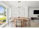 Bright dining area with modern table, chairs, and lighting fixtures near a large window offering natural light at 9485 Treasure Ne Ln, St Petersburg, FL 33702
