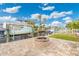View of backyard with patio, fire pit, and boat dock ready for waterfront living under sunny skies at 9485 Treasure Ne Ln, St Petersburg, FL 33702