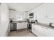 Contemporary kitchen with modern appliances, light countertops, and stylish cabinets with gold hardware at 9485 Treasure Ne Ln, St Petersburg, FL 33702