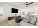Cozy living room with modern furnishings, polished concrete floors, and seamless flow to the outdoor spaces at 9485 Treasure Ne Ln, St Petersburg, FL 33702