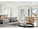 Comfortable seating area with modern decor, ample natural light, and convenient access to dining area at 9485 Treasure Ne Ln, St Petersburg, FL 33702