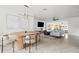 Open floor plan with modern dining area, comfortable living room, and sleek polished concrete floors at 9485 Treasure Ne Ln, St Petersburg, FL 33702