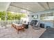 Covered patio with outdoor kitchen, ceiling fan, and lounge area at 9485 Treasure Ne Ln, St Petersburg, FL 33702