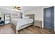 Bedroom featuring wood floors, a modern bed, and an elegant neutral color scheme at 9591 Commodore Dr, Seminole, FL 33776