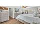 Calm bedroom with wood floors, stylish furniture, and plenty of natural light at 9591 Commodore Dr, Seminole, FL 33776