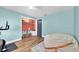 Cozy bedroom featuring a blue accent wall, unique built-ins, and hardwood floors at 9591 Commodore Dr, Seminole, FL 33776