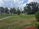 Scenic walking path winding through a green community space with mature trees and landscaping at 9591 Commodore Dr, Seminole, FL 33776