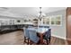 Bright dining room with seating for six, complemented by ample natural light and wood-look flooring at 9591 Commodore Dr, Seminole, FL 33776