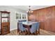 Cozy dining room features wood-look floors, natural lighting, and a bar area at 9591 Commodore Dr, Seminole, FL 33776