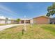 Charming single-story home with a well-maintained lawn and welcoming entrance at 9591 Commodore Dr, Seminole, FL 33776