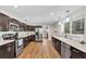 Open kitchen featuring stainless steel appliances, granite countertops and wood cabinets at 9591 Commodore Dr, Seminole, FL 33776
