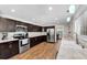Bright kitchen with stainless appliances, granite counters and dark wood cabinets at 9591 Commodore Dr, Seminole, FL 33776