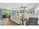 Open-concept living area with access to the outdoor pool and patio at 9591 Commodore Dr, Seminole, FL 33776