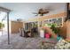 Charming covered patio with dining table, ceiling fans, and views of the lush backyard at 9591 Commodore Dr, Seminole, FL 33776