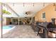 Spacious covered patio featuring an outdoor kitchen, ceiling fans, and dining area, perfect for entertaining at 9591 Commodore Dr, Seminole, FL 33776