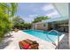 Inviting backyard with a pool, patio, and seating at 9591 Commodore Dr, Seminole, FL 33776