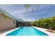 Gorgeous pool with covered patio, palm trees, and ample space for outdoor enjoyment at 9591 Commodore Dr, Seminole, FL 33776