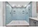 Spacious tiled walk-in shower with dual shower heads and built-in niches at 9591 Commodore Dr, Seminole, FL 33776