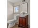 Bathroom featuring dark wood vanity and a decorative mirror at 100 E Fern St, Tampa, FL 33604