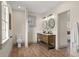 Spacious bathroom with double sink vanity, wood-look floors, and great natural light at 100 E Fern St, Tampa, FL 33604
