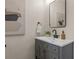 Modern bathroom with gray vanity, black faucet and framed mirror, plus stylish decor at 100 E Fern St, Tampa, FL 33604